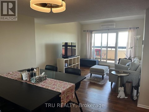 A living room with a black table and a television.