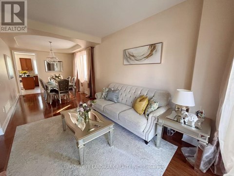 A living room with a white couch and a coffee table.