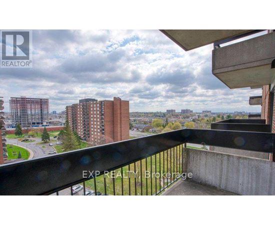 A balcony with a view of a cityscape and buildings.
