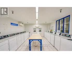 A laundromat with a sign that says EXP Realty Brokerage.