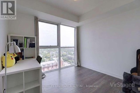A room with a large window overlooking a cityscape.