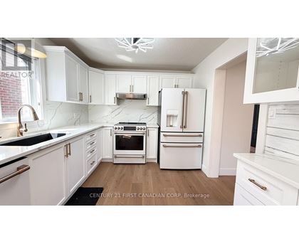 A kitchen with white cabinets and appliances.
