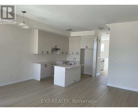 A kitchen with white cabinets and a sink.