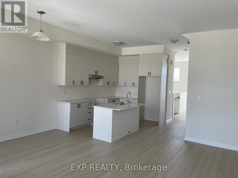 A kitchen with white cabinets and a sink.