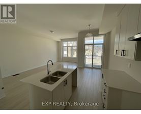A kitchen with a sink and a window.