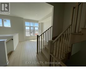 A staircase in a house with EXP REALTY, Brokerage written on the wall.