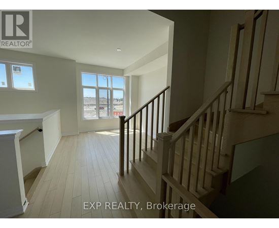 A staircase in a house with EXP REALTY, Brokerage written on the wall.