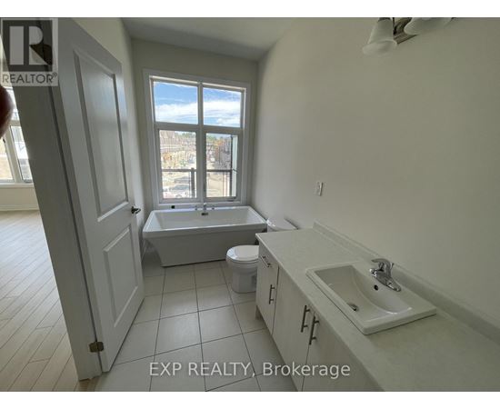 A bathroom with a tub, toilet, and sink.