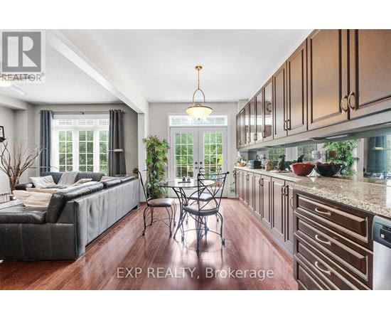 A well-lit kitchen with wooden cabinets and a dining table with chairs.