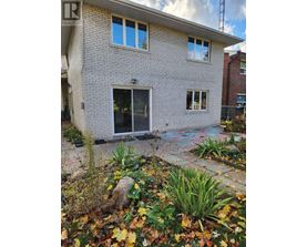 A house with a grey brick exterior and a glass door.