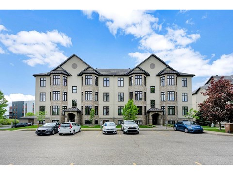 A large building with a parking lot in front of it.