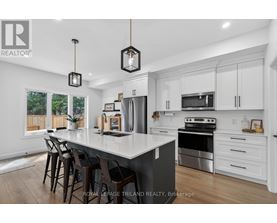 A modern kitchen with white cabinets and a large island.