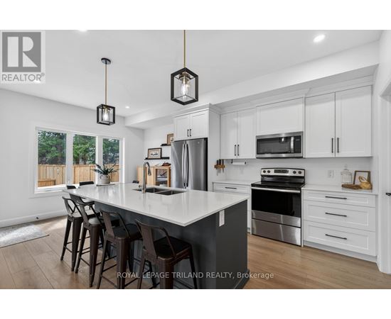 A modern kitchen with white cabinets and a large island.