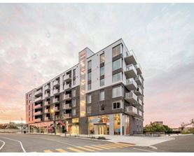 A modern apartment building with a street in front.