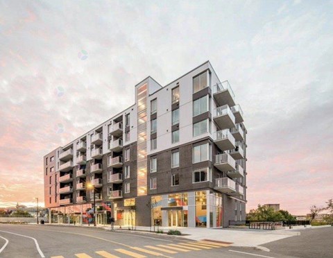 A modern apartment building with a street in front.