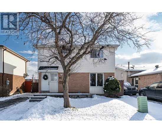 A house with a white door and a tree in front of it.