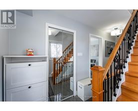 A white cabinet with a drawer and a door is in the room.