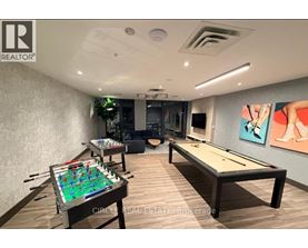 A room with a pool table and air hockey table.