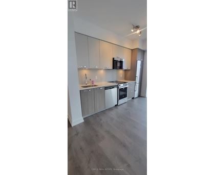 A modern kitchen with wooden cabinets and stainless steel appliances.