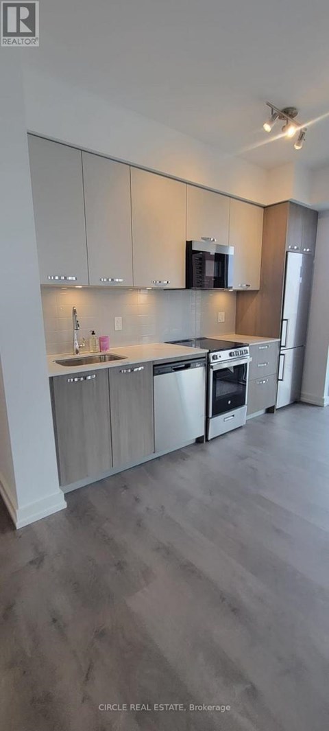 A modern kitchen with wooden cabinets and stainless steel appliances.