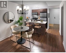 A modern kitchen with a round table and chairs.