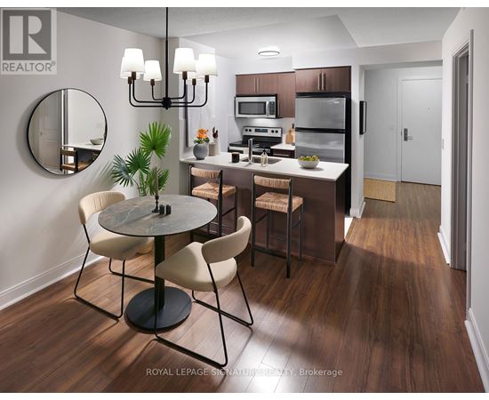 A modern kitchen with a round table and chairs.