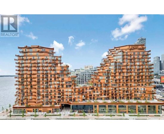 A modern building with a curved design is situated by the water.
