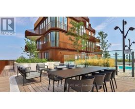 A modern building with a pool and a table set up for dining.