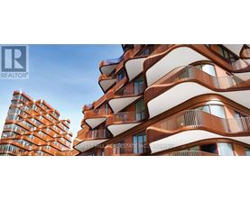 A tall building with a curved design is in the background, while a smaller building with balconies is in the foreground.