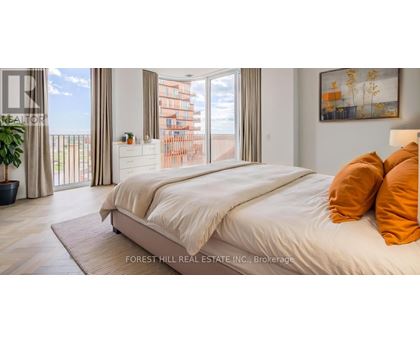 A bedroom with a large bed and a view of a balcony with a building in the background.