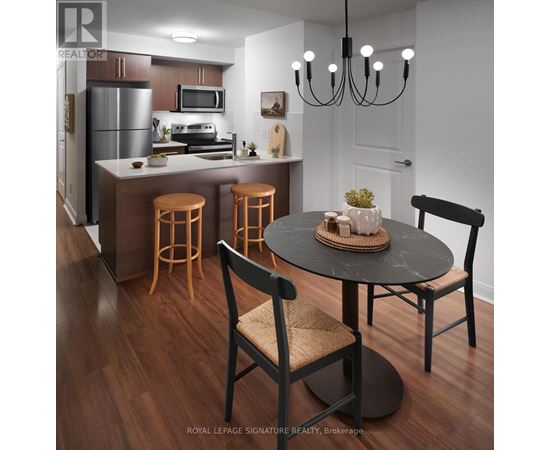A modern kitchen with a dining table and chairs.