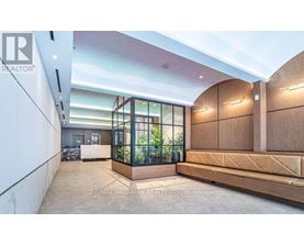 A modern interior space with a glass enclosed area and wooden furniture.