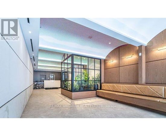 A modern interior space with a glass enclosed area and wooden furniture.