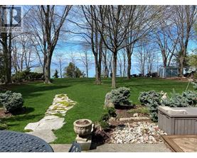 A backyard with a hot tub and a stone pathway.