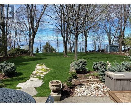 A backyard with a hot tub and a stone pathway.
