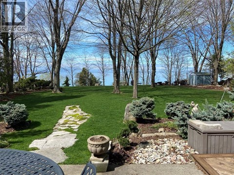 A backyard with a hot tub and a stone pathway.