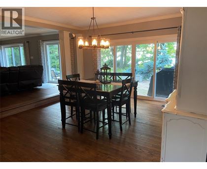A dining room with a table and chairs is shown.
