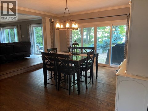 A dining room with a table and chairs is shown.