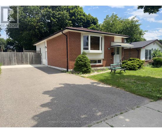 A house with a driveway and a green bench in front of it.