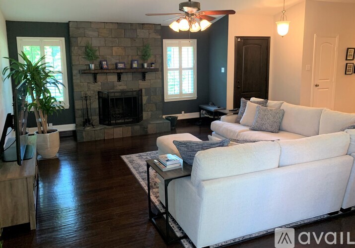 A living room with a fireplace and a white couch.