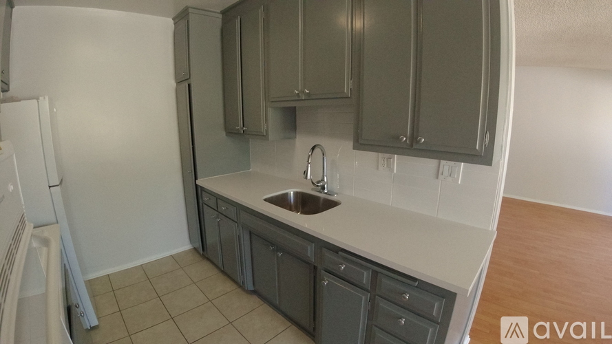 A kitchen with a sink and cabinets.
