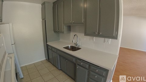 A kitchen with a sink and cabinets.