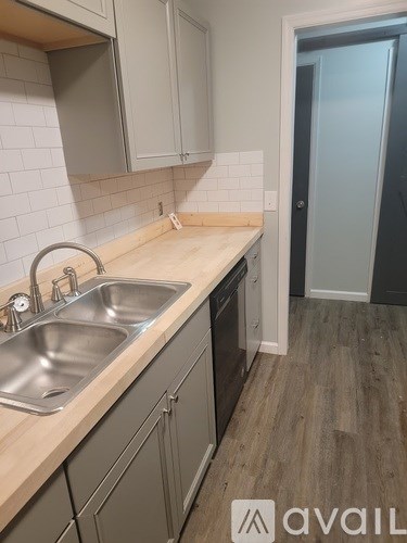 A kitchen with a sink and a door.