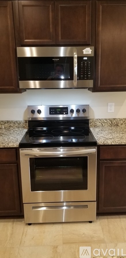 A kitchen with a stove top oven and microwave above it.