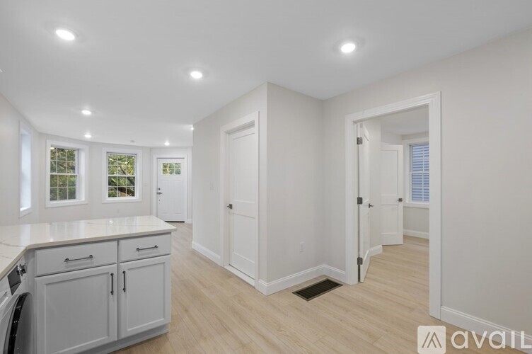 A kitchen with white cabinets and a countertop is available.