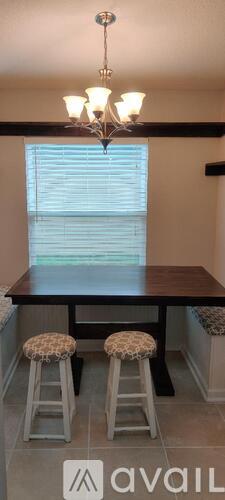 A dining room with a wooden table and chairs.