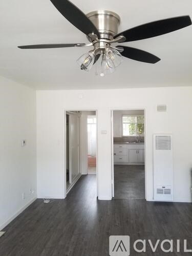 A room with a ceiling fan and a logo that says "avaiL".