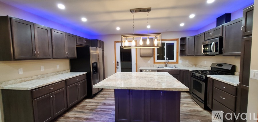 A kitchen with a large island in the middle.