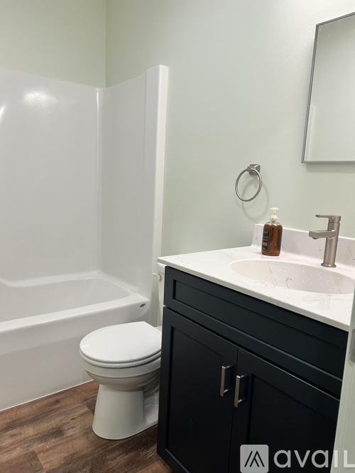 A bathroom with a white toilet and a white sink.