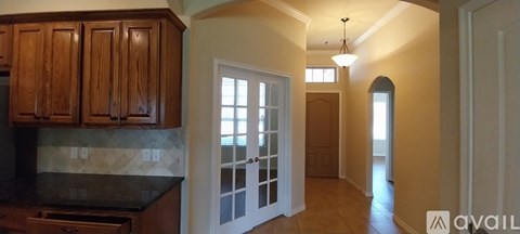 A kitchen with wooden cabinets and a black countertop.